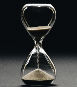 hourglass representing eliminated inefficiencies because of DevOps - Techigai